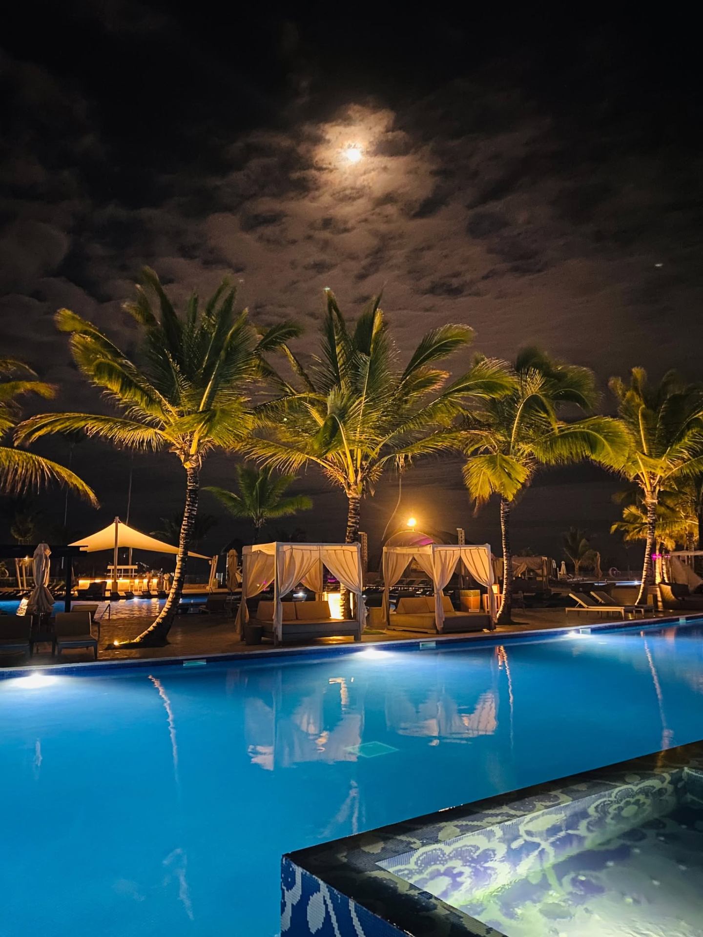 Moonlit pool and palms at Royalton CHIC Punta Cana